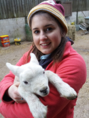 Vacations in the countryside- Woman holding a lamb